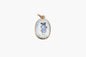 Gold pendant with a blue and white design on a white background