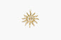 Gold sun-shaped pendant on a white background