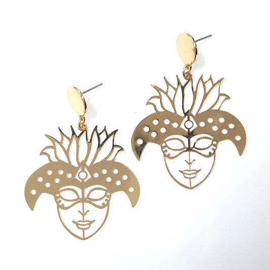 Gold mask-shaped earrings on a white background