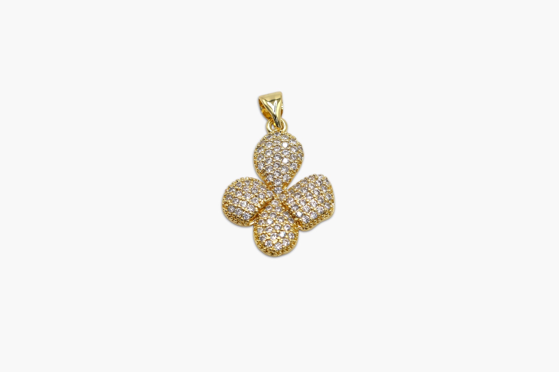 Gold four-leaf clover pendant on a white background