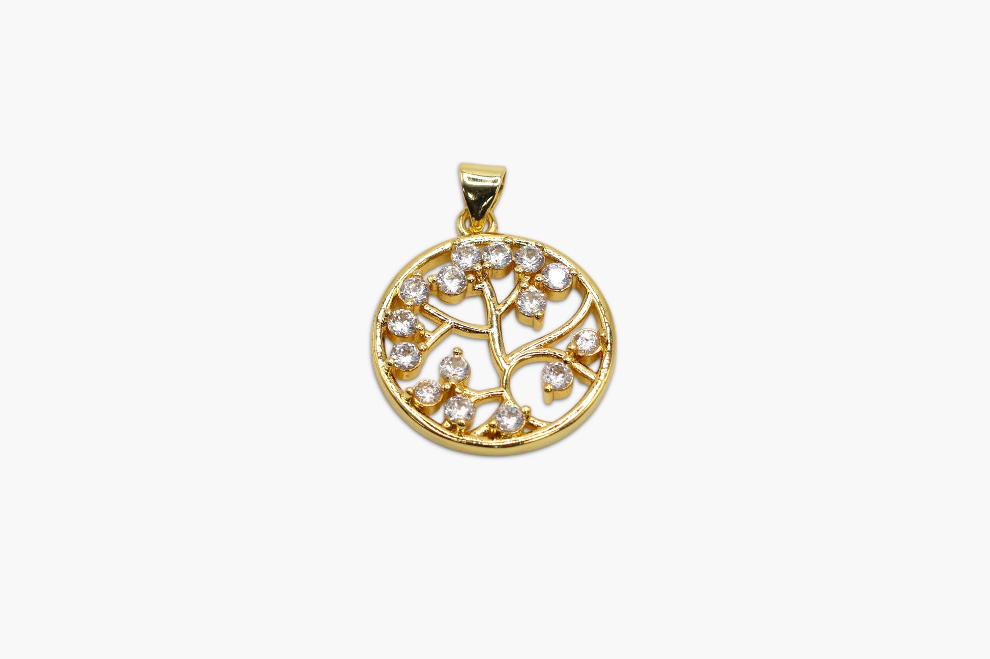 Gold pendant with diamond tree of life design on a white background