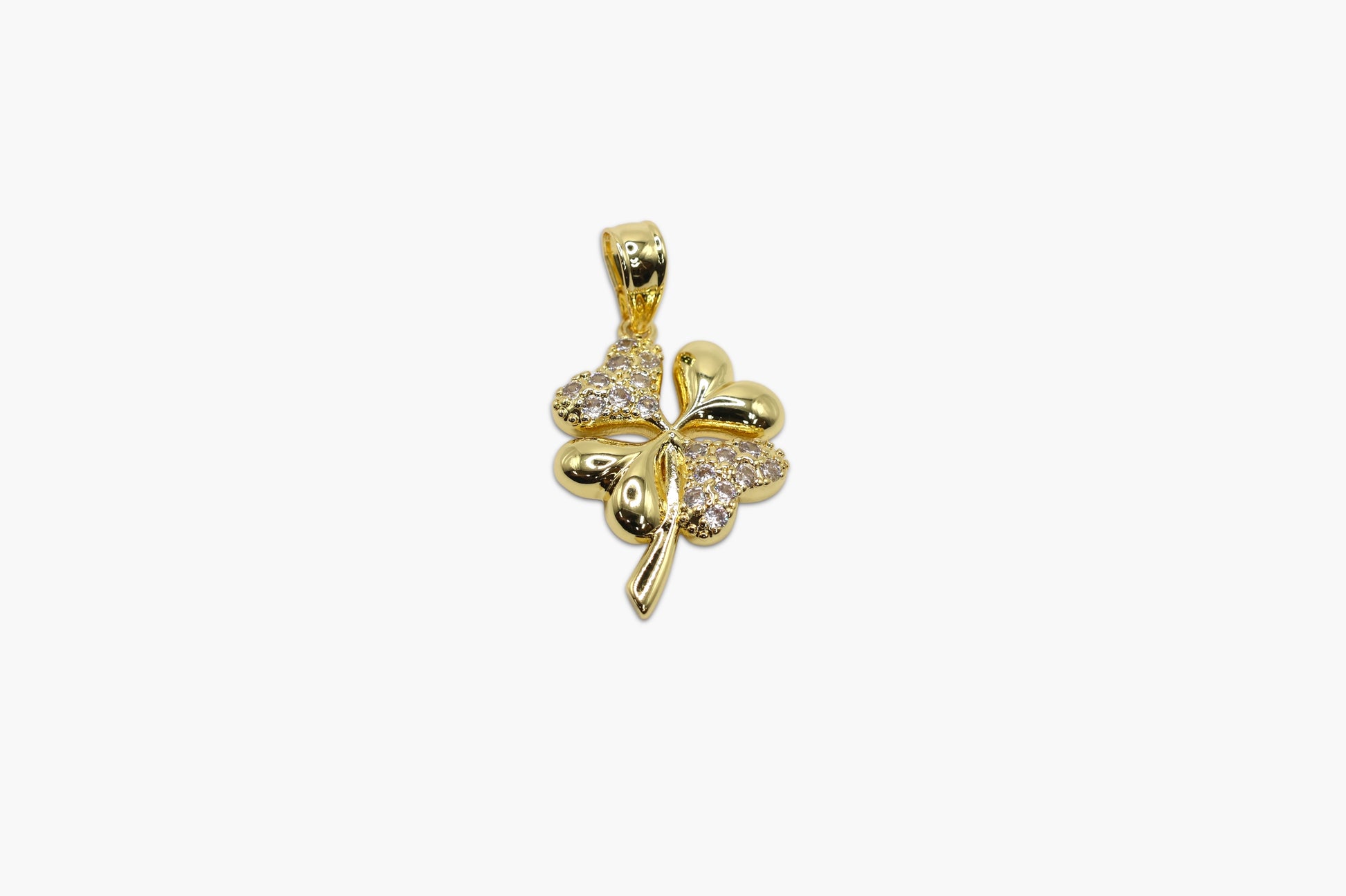 Gold four-leaf clover pendant with clear stones on a white background