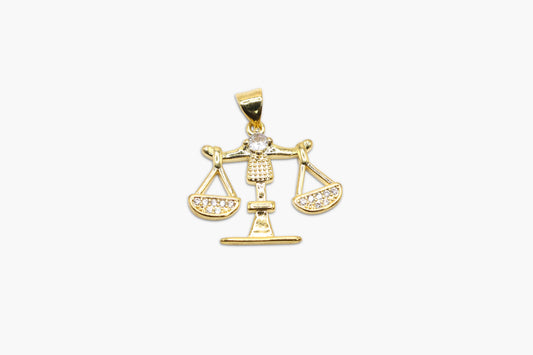 Gold pendant with a Libra design on a white background
