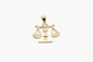 Gold pendant with a Libra design on a white background