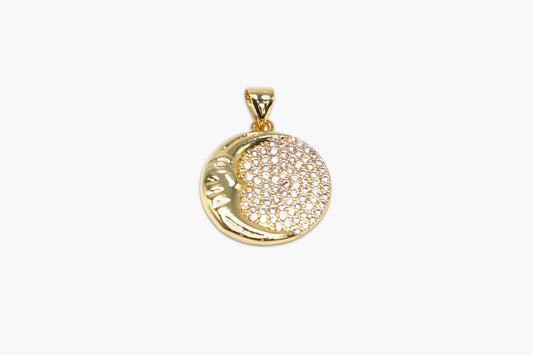 Gold pendant with a circular design on a white background