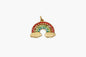 Gold rainbow charm with colorful stones on a white background