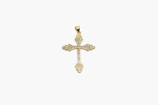 Gold cross pendant on a white background