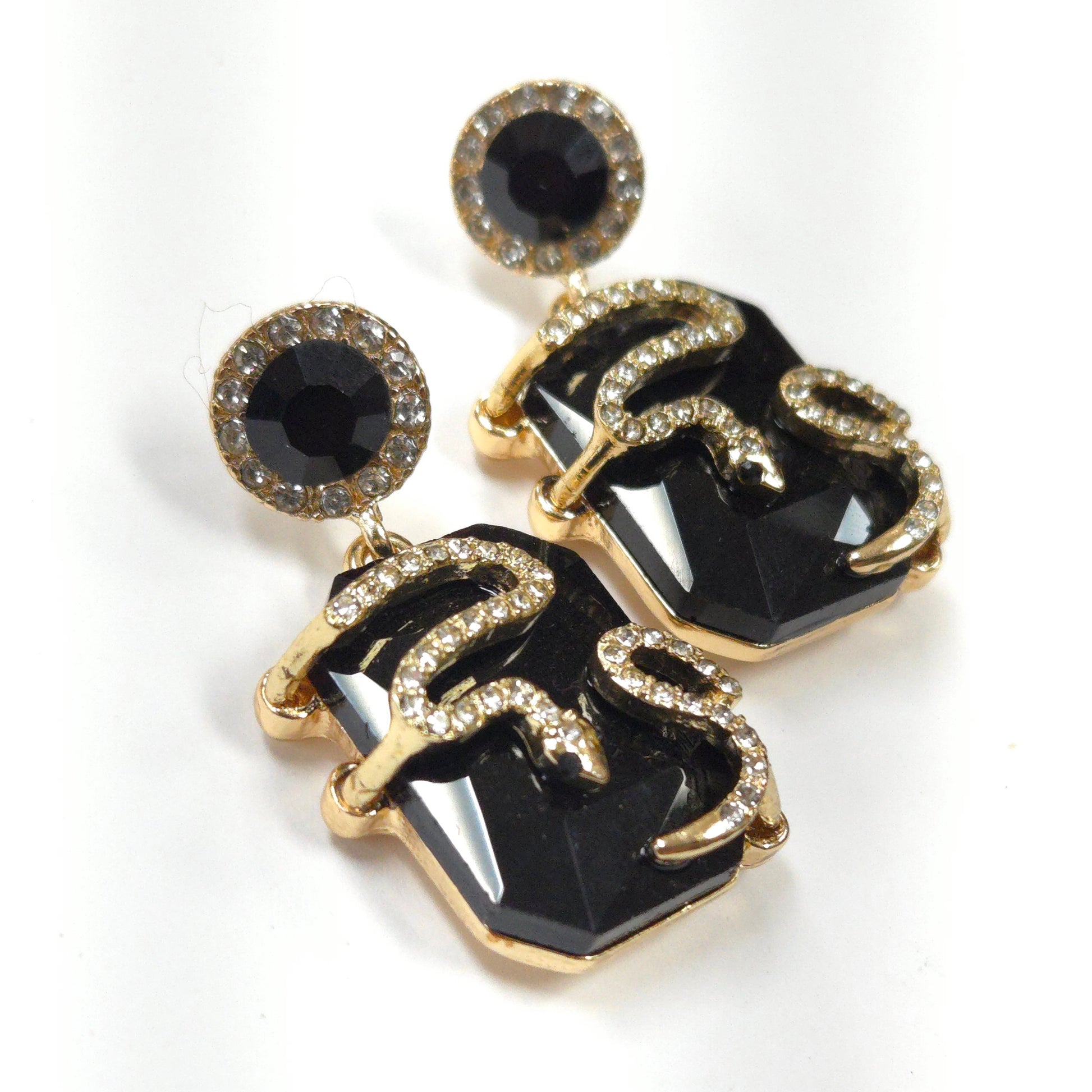 Black and gold earrings on a white background