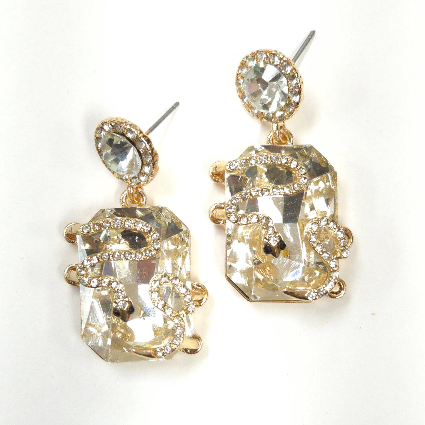 Pair of gold and crystal earrings on a white background