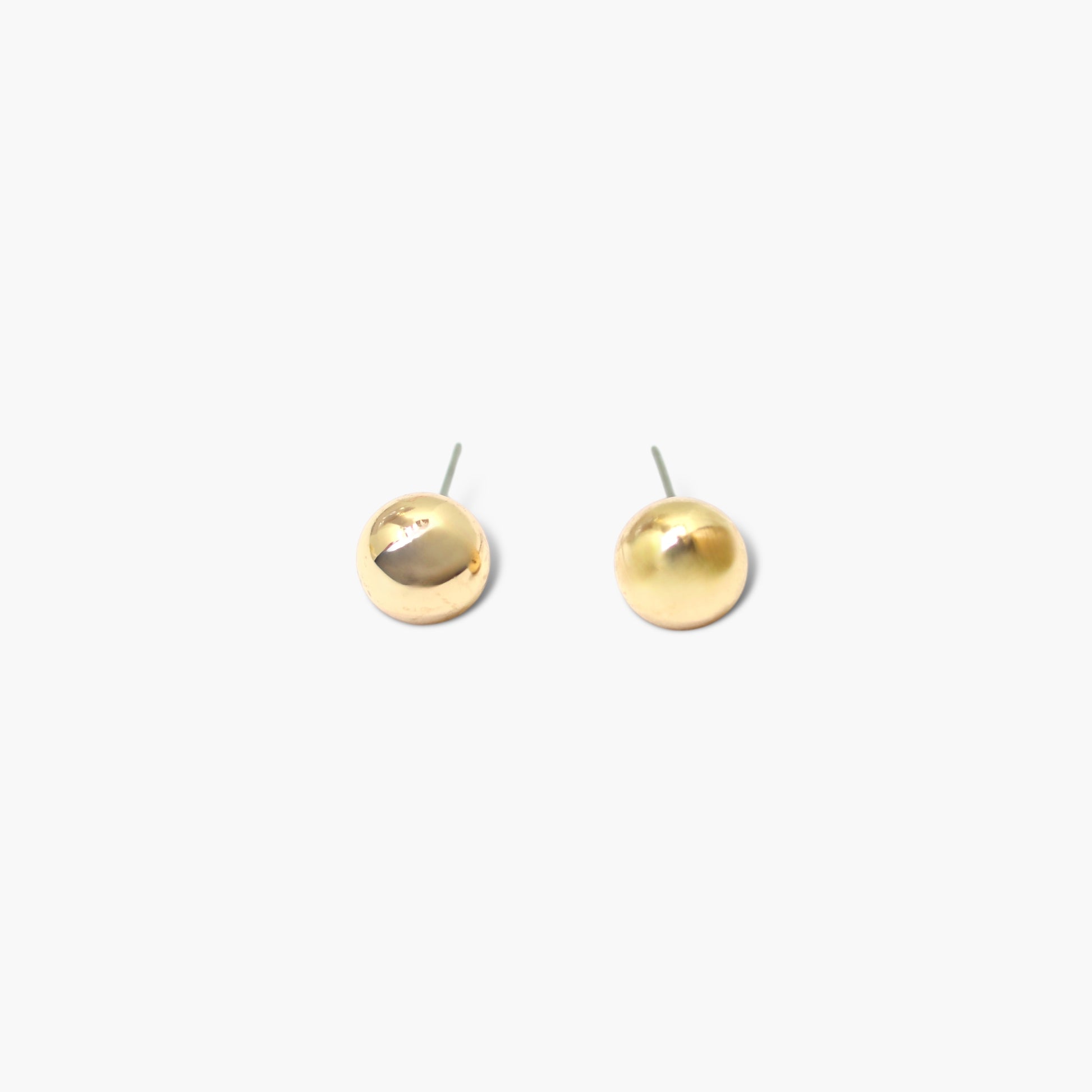 A pair of gold earrings on a white background