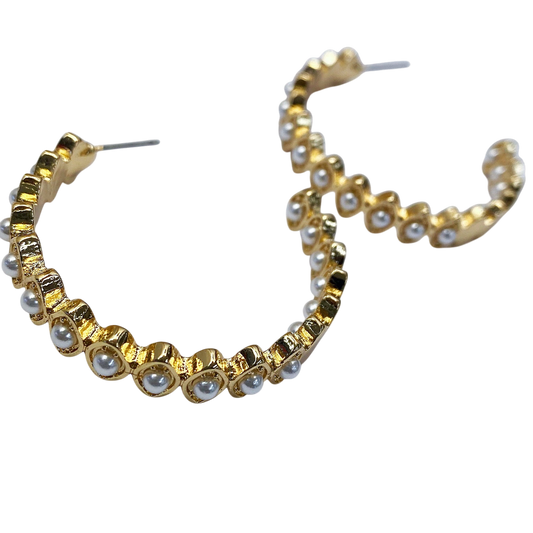 Gold hoop earrings with pearl accents on a white background