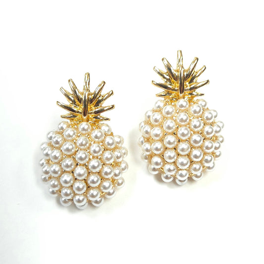 Pineapple-shaped earrings with pearl details on a white background