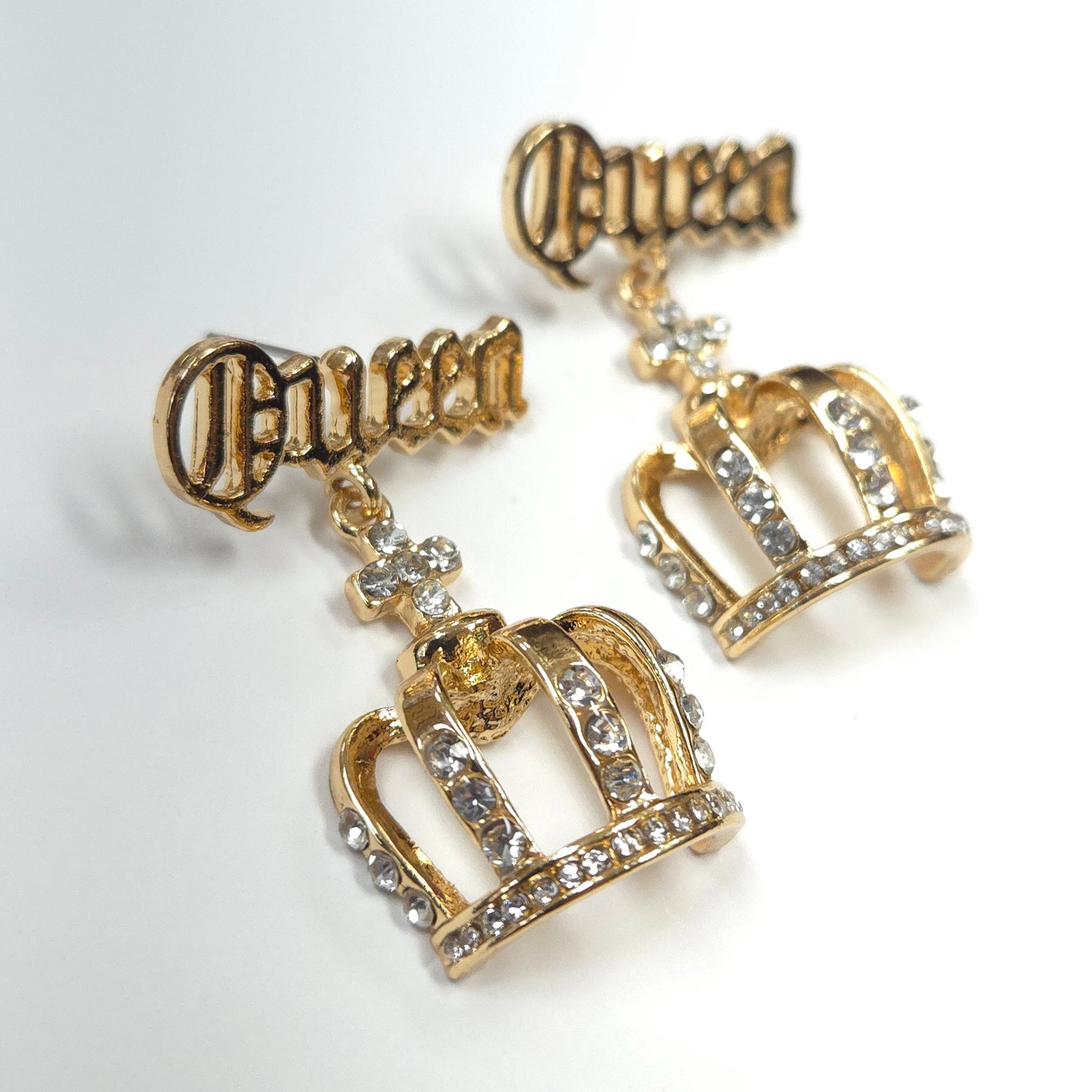 Gold crown earrings with 'Princess' text on a white background