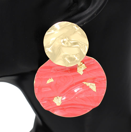 Earring with gold and red design on a black background