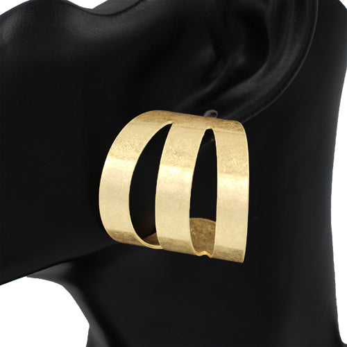Gold hoop earring on a black mannequin ear