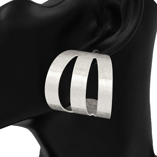 Silver hoop earring on a black mannequin ear