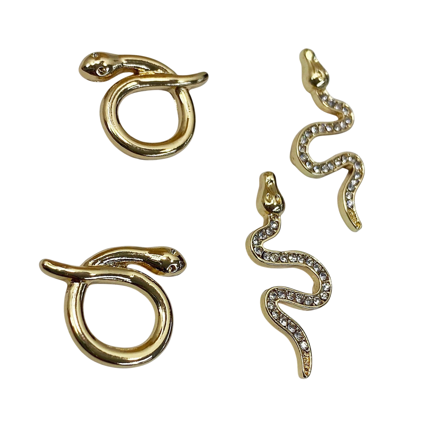 Gold snake-shaped earrings on a white background