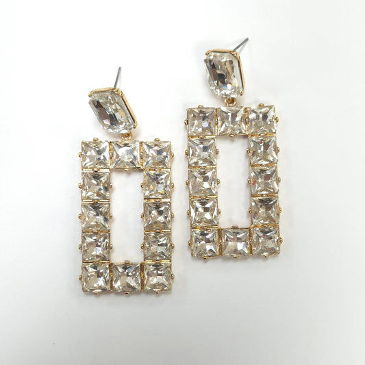 Pair of gold-framed crystal earrings on a white background