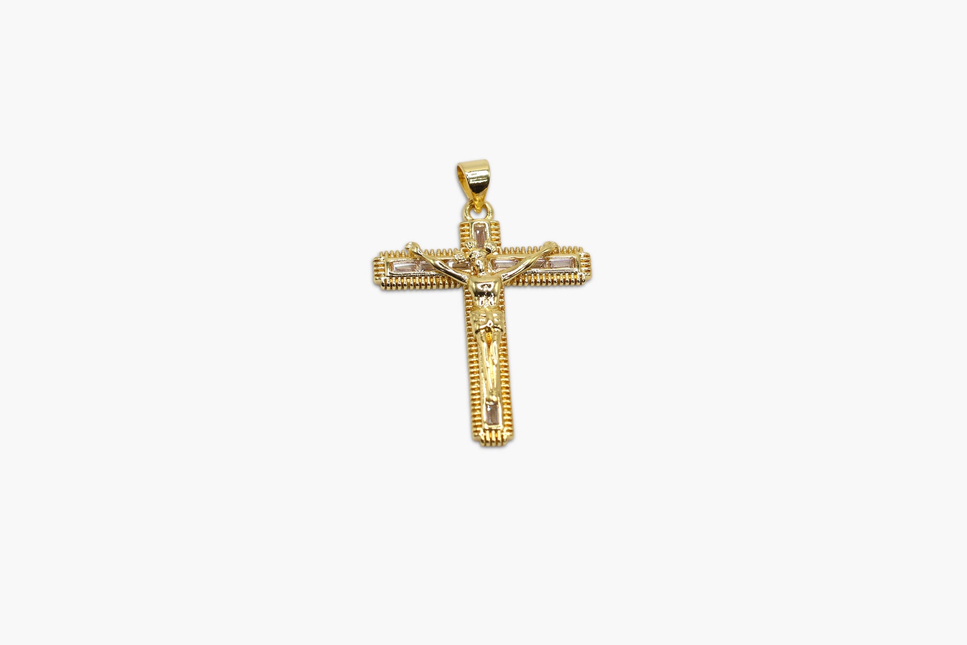 Gold cross pendant on a white background