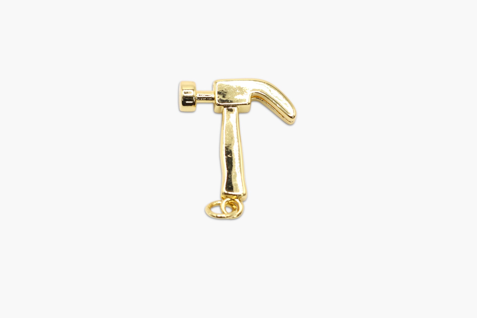 Gold hammer-shaped charm on a white background