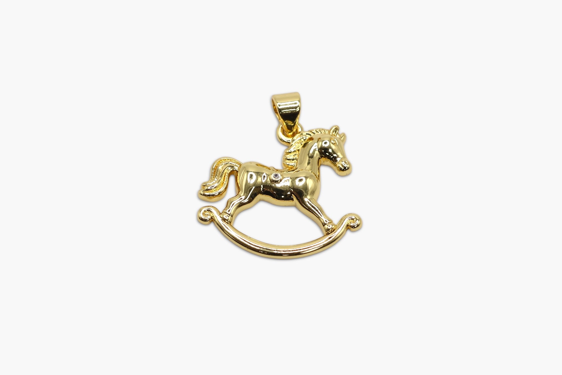 Gold rocking horse pendant on a white background