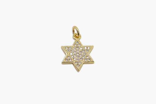 Gold star-shaped pendant with embedded stones on a white background